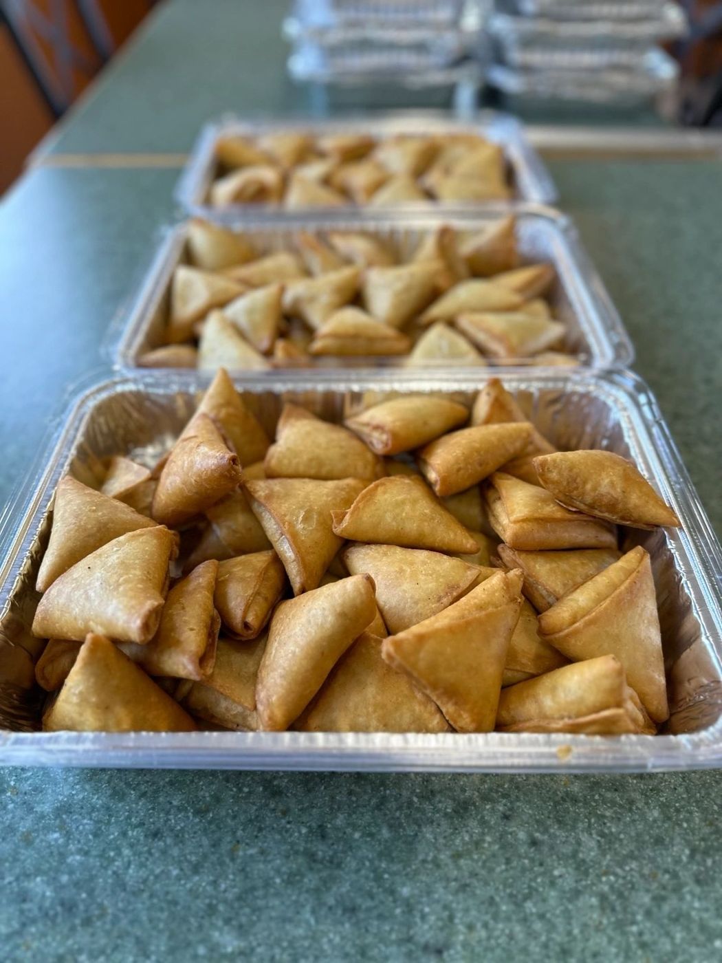 Catering trays of golden fried pastries